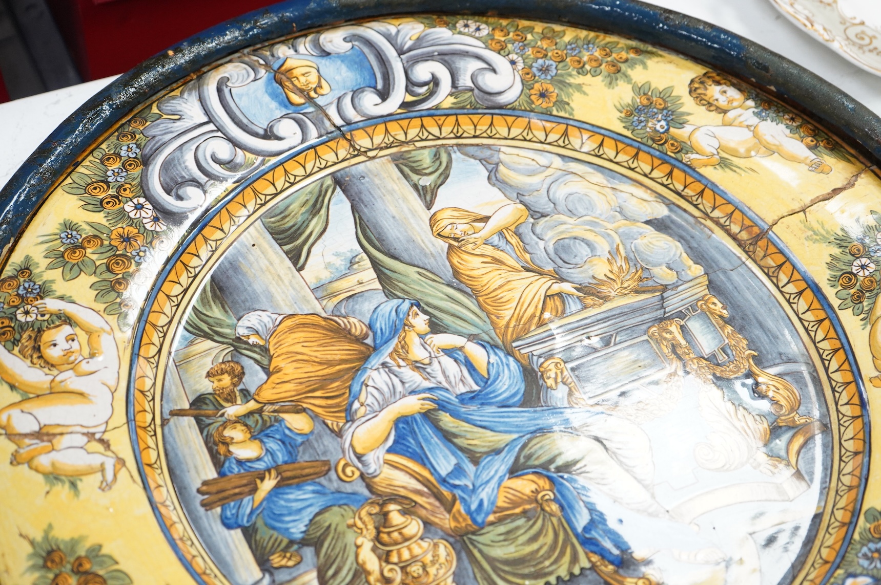A 19th century Italian maiolica istoriata charger (riveted), framed, 56cm in diameter overall